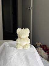 Sculpted ivory bear candle covered in tiny roses, holding a heart
