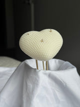 Sculpted ivory heart candle with a dotted texture and three wicks