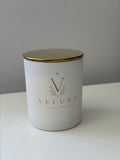 Veluno Alabaster — matte white jar candle with a gold lid and the Veluno monogram