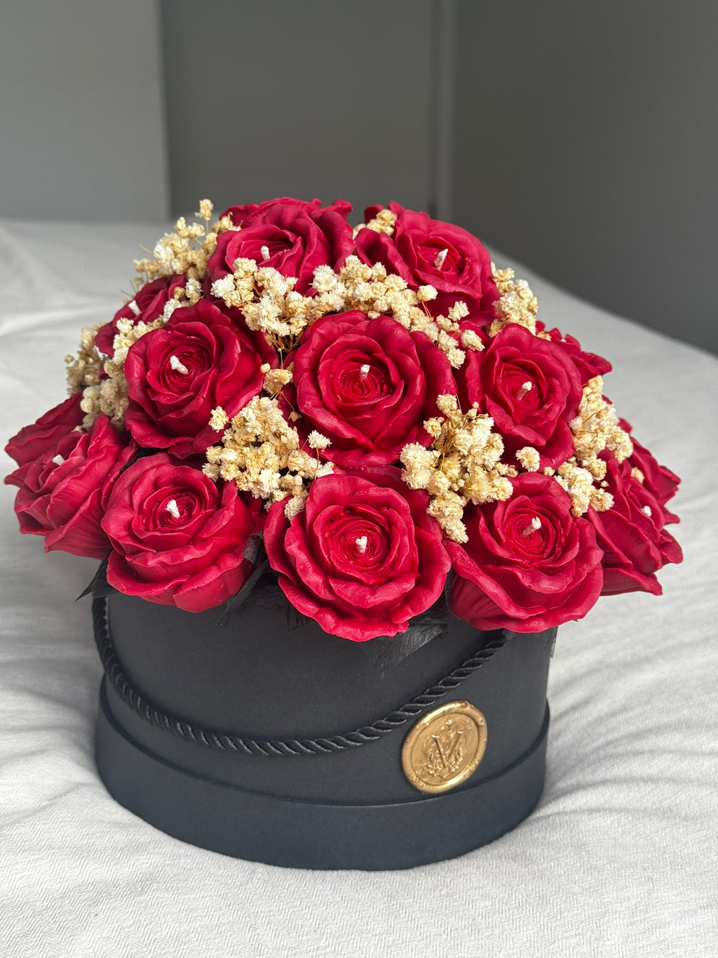 Veluno Noir Rouge red rose wax flower bouquet in a black hat box